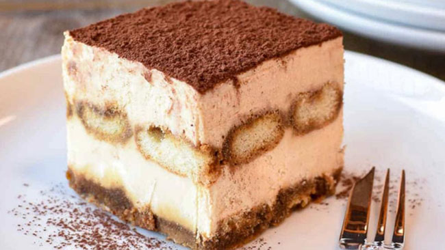 a beautiful picture of a fresh cut piece of Tiramisu